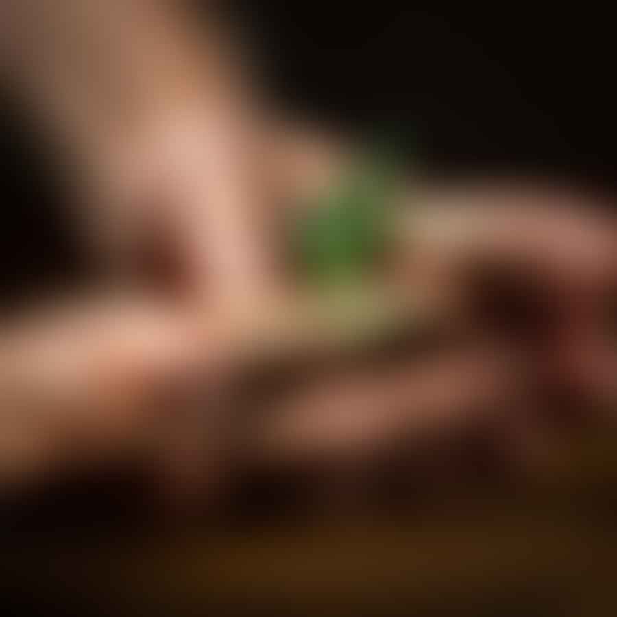 Person applying cannabis topical on their hand for pain relief